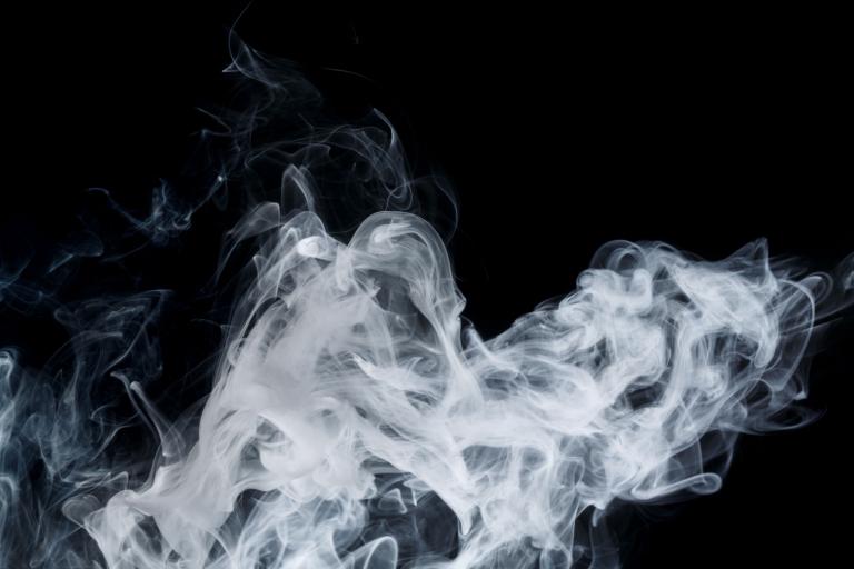 A cloud of smoke on a black background.